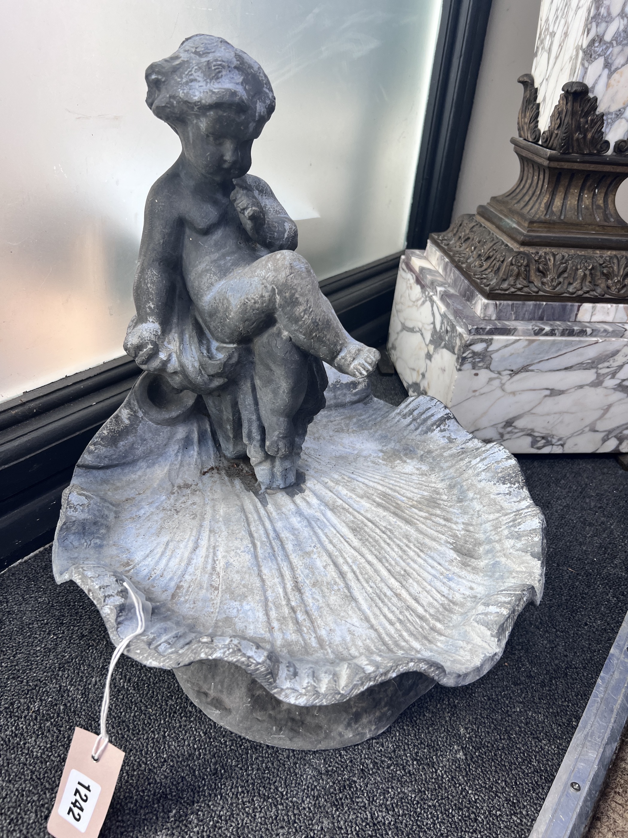 A lead putti and scallop shell bird bath, height 42cm